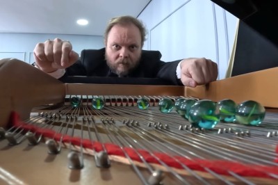 Playing a Grand Piano With Marbles on the Strings